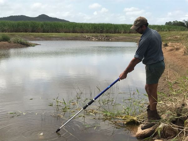 Photo Credit- Farmacist. Photo Caption-Steve Muscat from Oakenden near Mackay collecting a water sample from his sediment detention basin.jpg